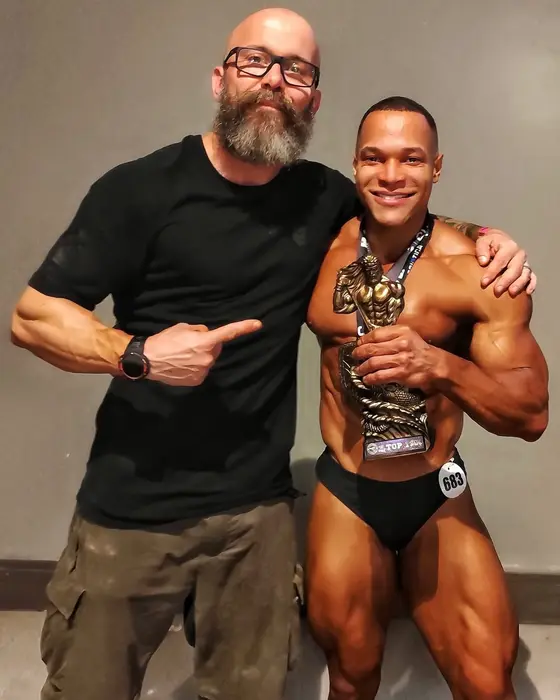 Ricardo com um atleta segurando o troféu